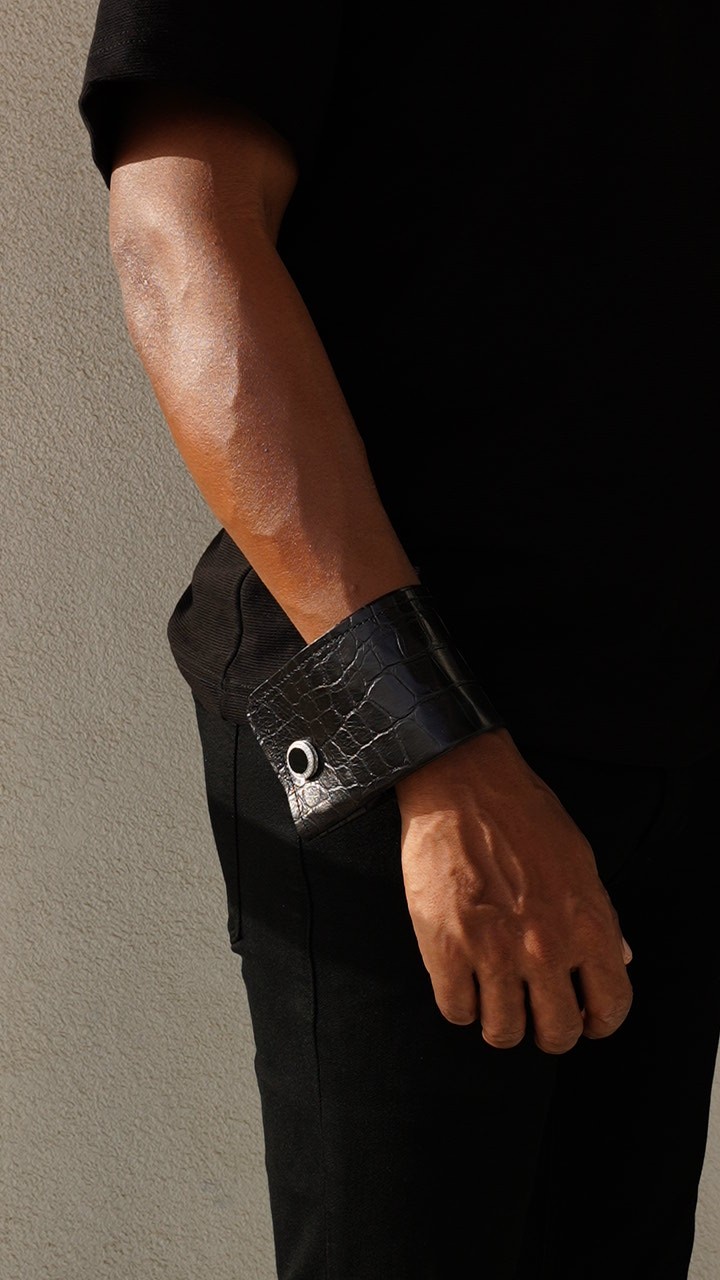 Black textured VALEUR cuff showing its folded silhouette on the wrist